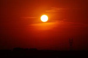 Sun setting on horizon